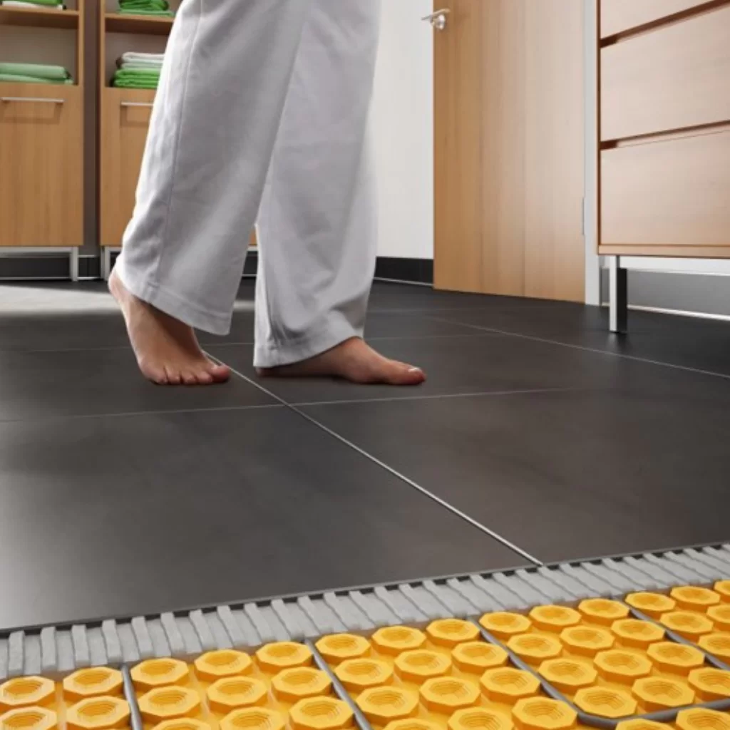 Radiant heated tile flooring with Schluter uncoupling membrane installation