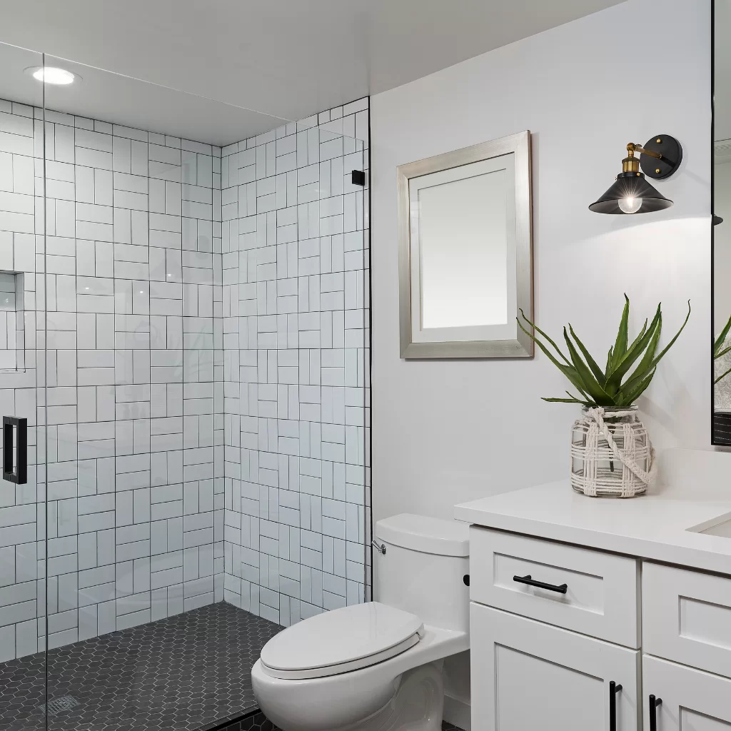Glass shower with floating vanity and white tile walls