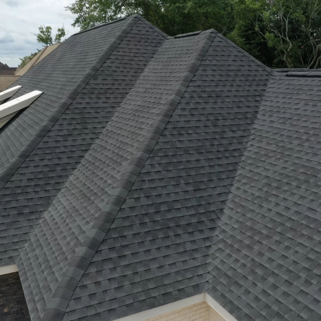 Ridge view of sloped shingle roof with clean valley and hip transitions