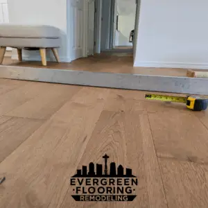 10-foot straightedge showing a visible gap under hardwood floor due to uneven subfloor